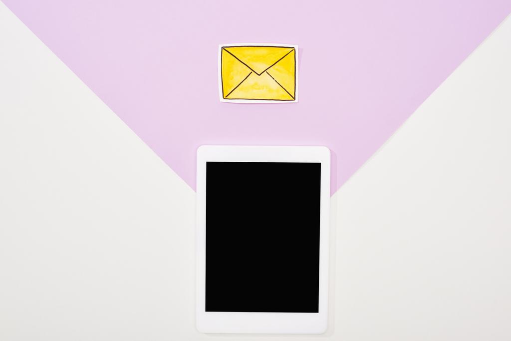 紫と白の背景に空白の画面と紙カットメッセージアイコンを持つデジタルタブレットのトップビュー - 写真・画像