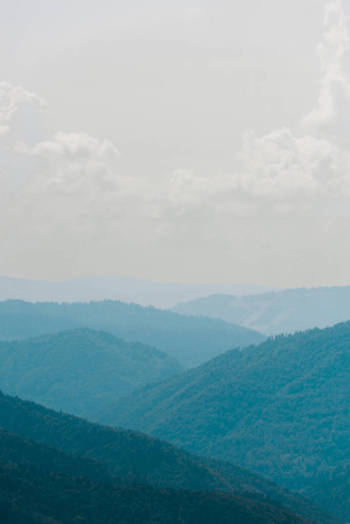 тиха гірська долина на тлі неба білі хмари
  - Фото, зображення