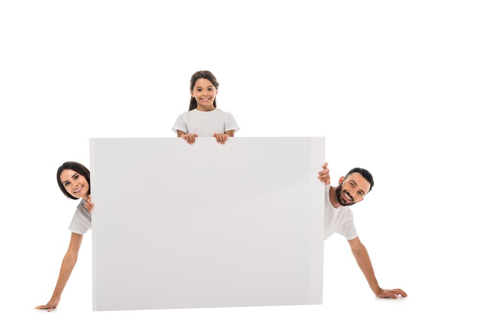 cheerful parents and happy daughter near blank placard isolated on white  - Photo, Image