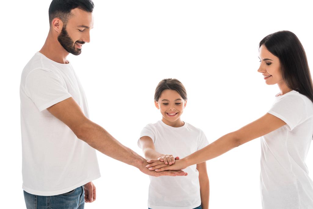 ευτυχισμένη οικογένεια βάζοντας τα χέρια μαζί απομονώνονται σε λευκό  - Φωτογραφία, εικόνα