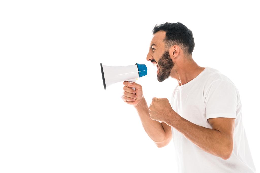 side view of angry man with clenched fist screaming in megaphone isolated on white  - 写真・画像