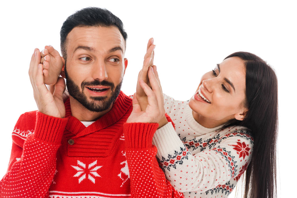 happy woman touching hands of bearded man in sweater isolated on white  - 写真・画像