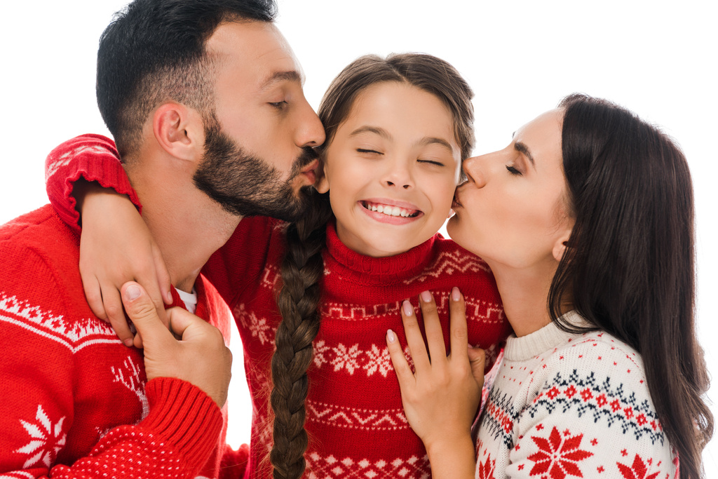 happy parents kissing cheeks of daughter in sweater isolated on white  - Photo, Image