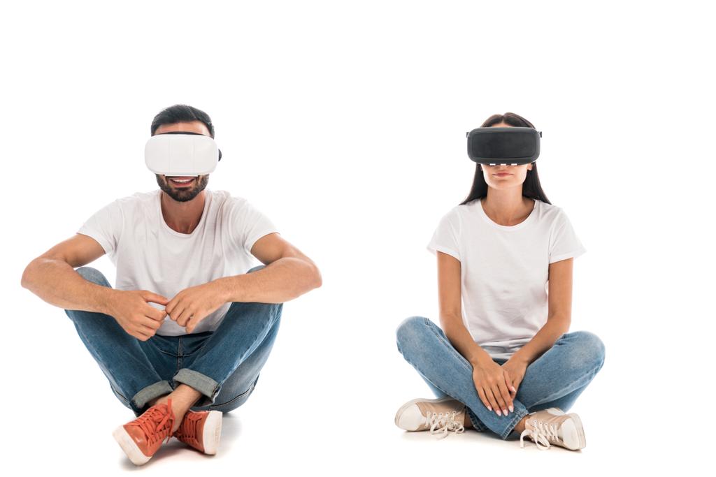 happy man sitting near woman while using virtual reality headset on white  - Photo, Image