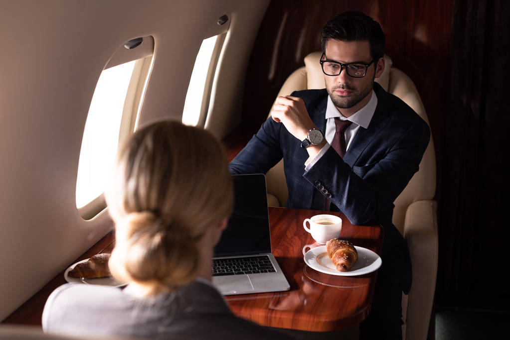 corporate businesspeople working with laptop in airplane  - 写真・画像