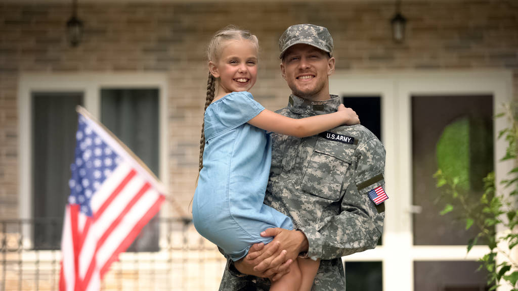 Guapo soldado de EE.UU. en uniforme militar sosteniendo hija feliz, regreso a casa
 - Foto, imagen