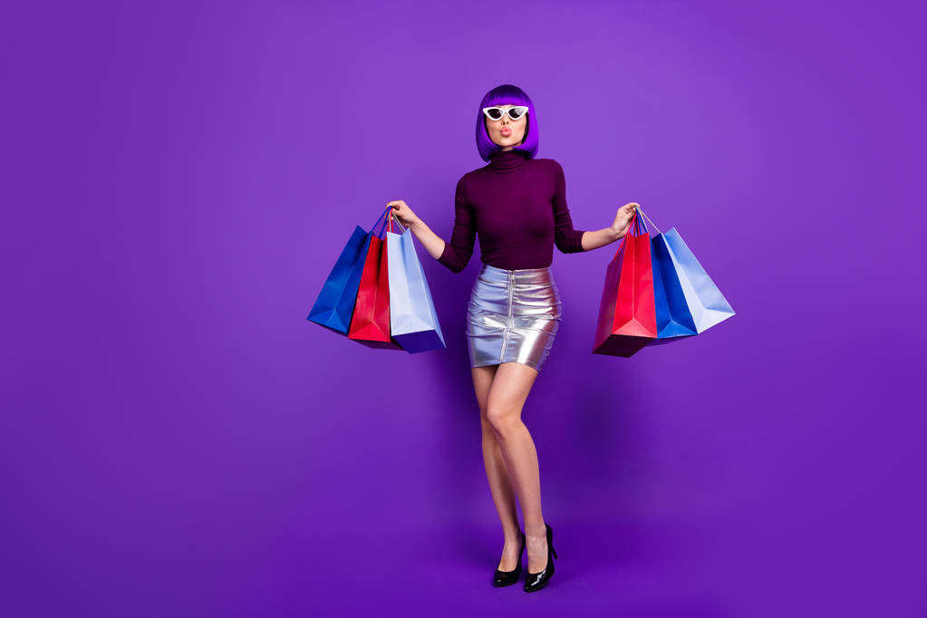 Photo of beautiful stylish lady holding many packs in hands send air kiss wear trendy outfit isolated purple background - Photo, Image