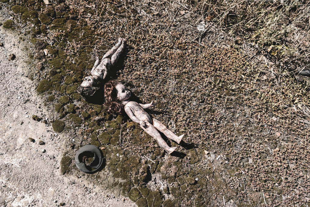 top view of scary and burnt baby dolls on ground, post apocalyptic concept - Photo, Image