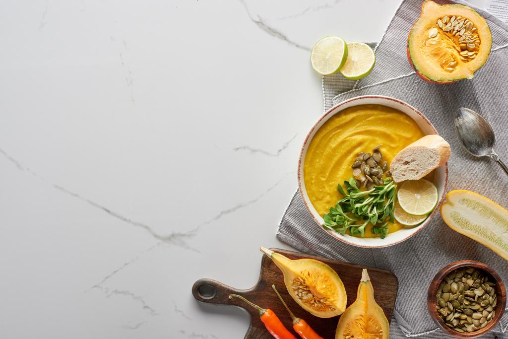 top view of autumnal mashed pumpkin soup on marble surface - Photo, Image