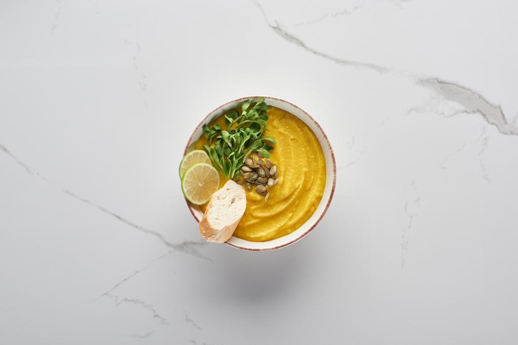 top view of tasty mashed pumpkin soup on marble surface - Photo, Image