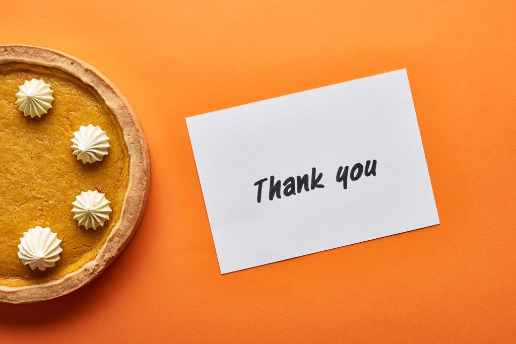 top view of pumpkin pie and thank you card on orange background - Photo, Image