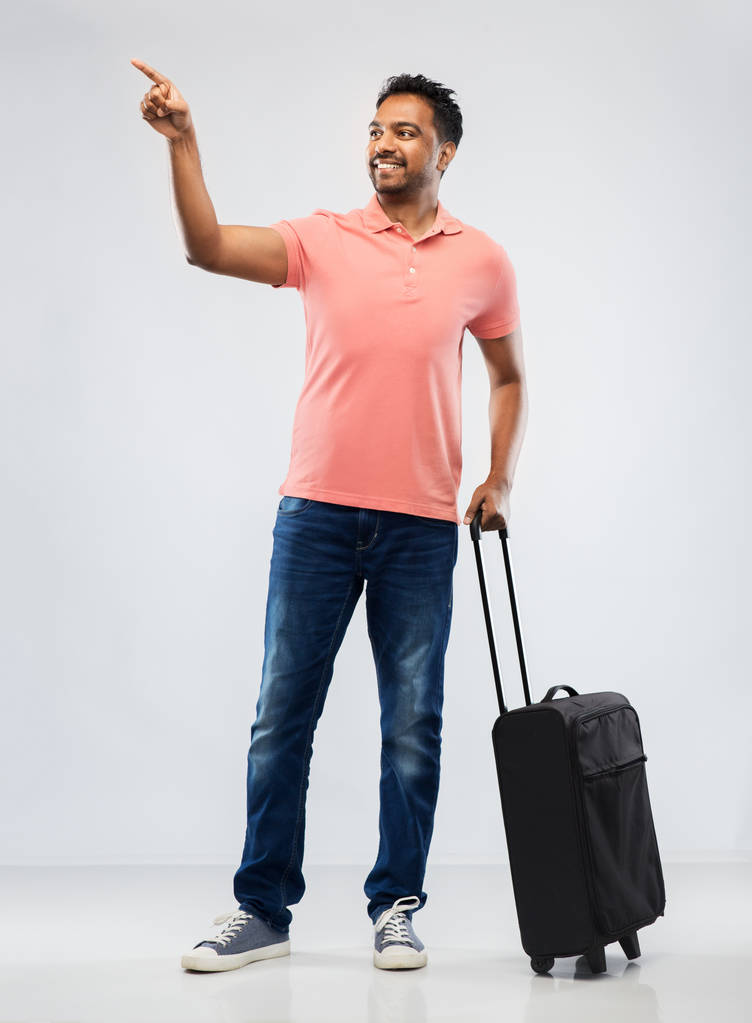 hombre indio sonriente en polo con bolsa de viaje
 - Foto, imagen
