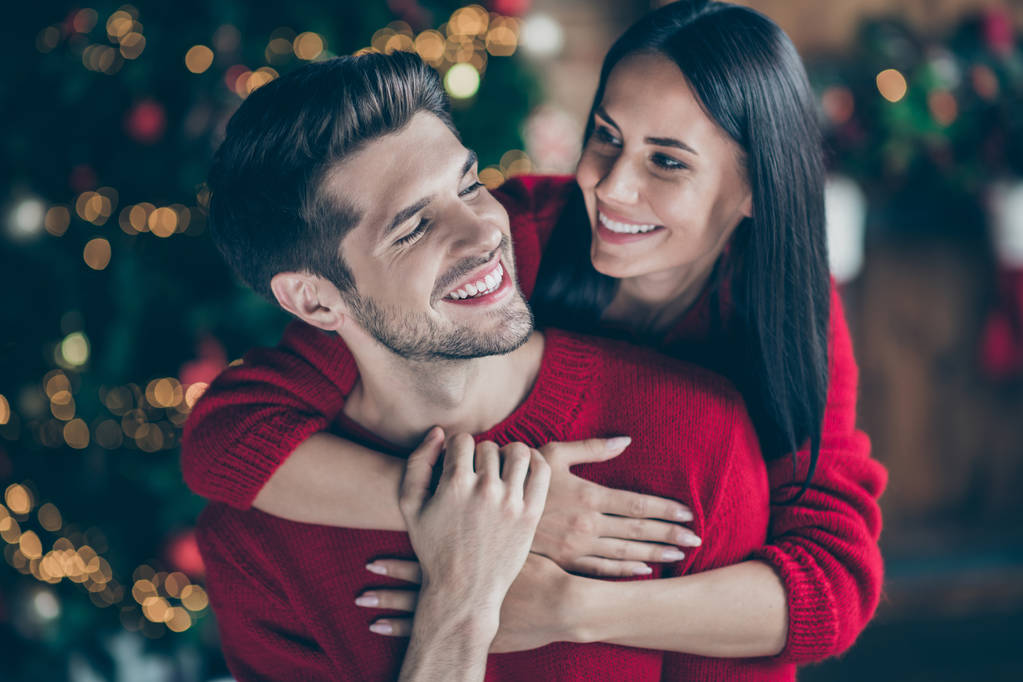 Close up photo of two people romantic dreamy man and woman hug gently piggyback in house with newyear decoration lights indoors enjoy christmas vacation x-mas holidays - Photo, Image