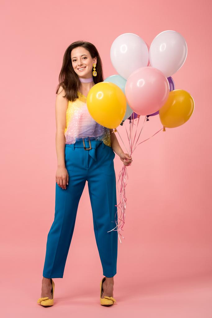 young happy party girl holding festive balloons on pink - Photo, Image