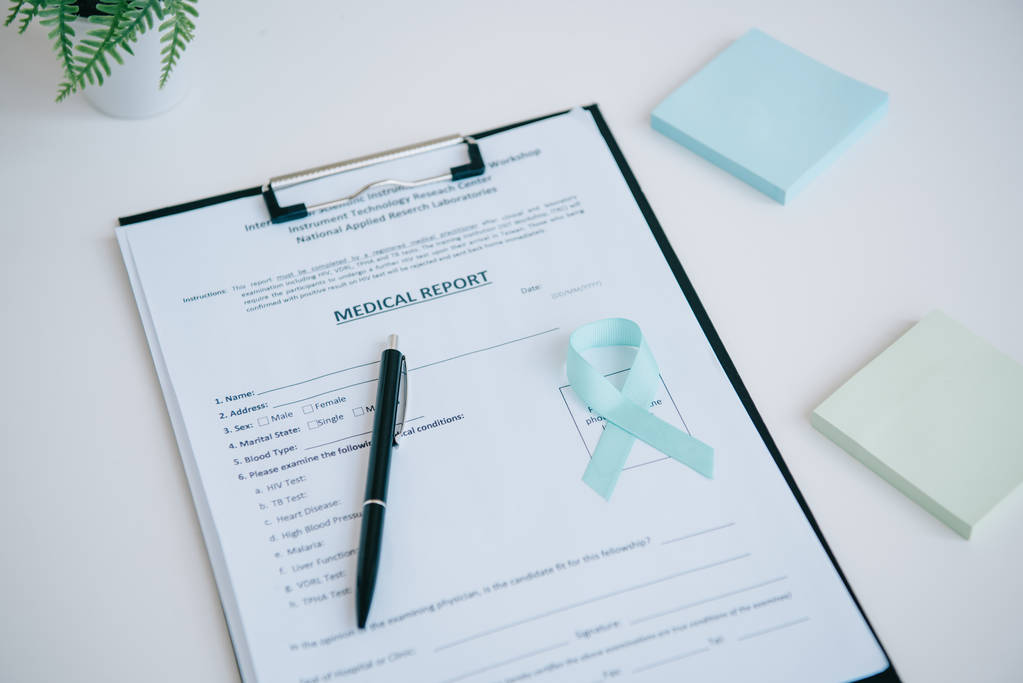 blue awareness ribbon on medical report near pen and sticky notes - Photo, Image