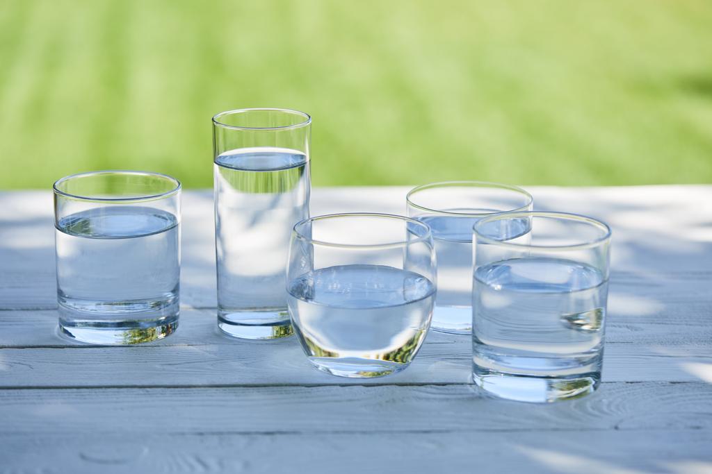eau douce claire dans des verres transparents à la lumière du soleil sur une table en bois
 - Photo, image