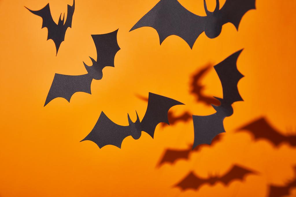 paper bats with shadow on orange background, Halloween decoration - Photo, Image
