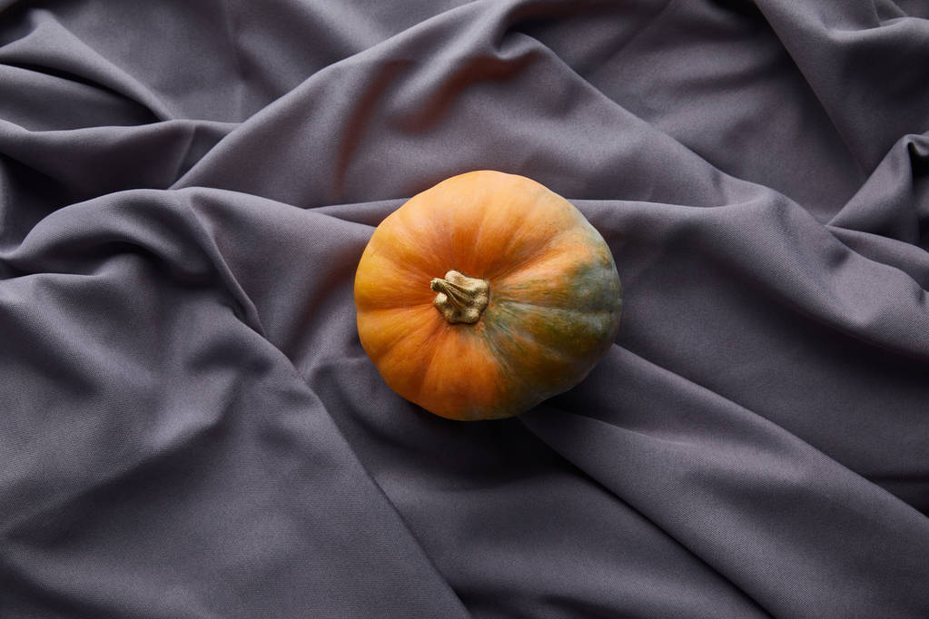 ripe whole colorful pumpkin on grey cloth - Photo, Image