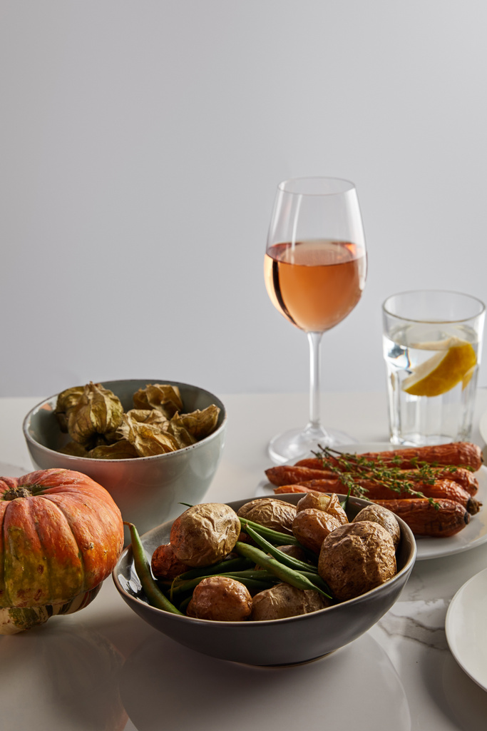 festive thanksgiving dinner with baked vegetables served on marble table isolated on grey - Photo, Image