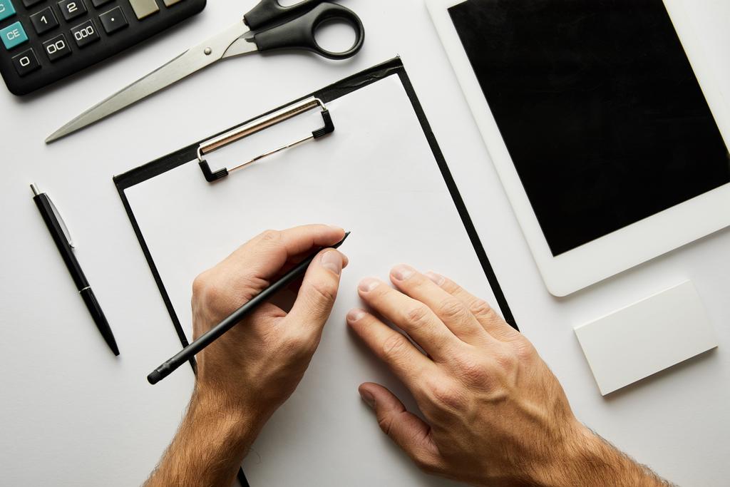 cropped view of man writing in clipboard with pen  - Photo, Image