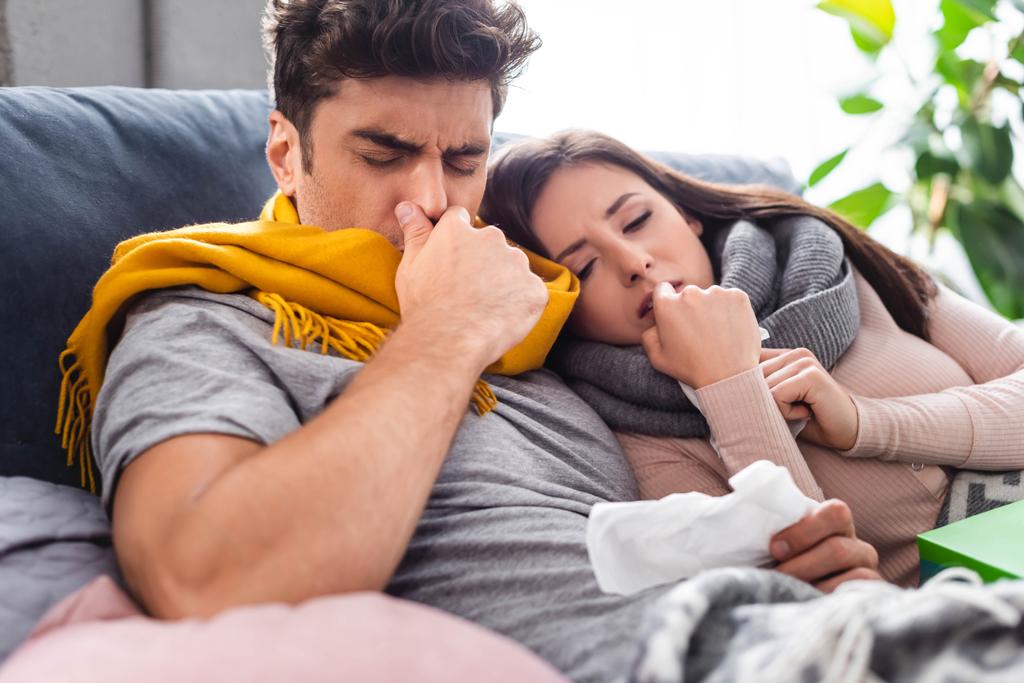 sick girlfriend and handsome boyfriend sneezing and holding napkins  - Photo, Image