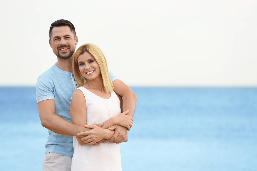 Χαρούμενο ρομαντικό ζευγάρι που περνά χρόνο μαζί στην παραλία, Χώρος για κείμενο - Φωτογραφία, εικόνα
