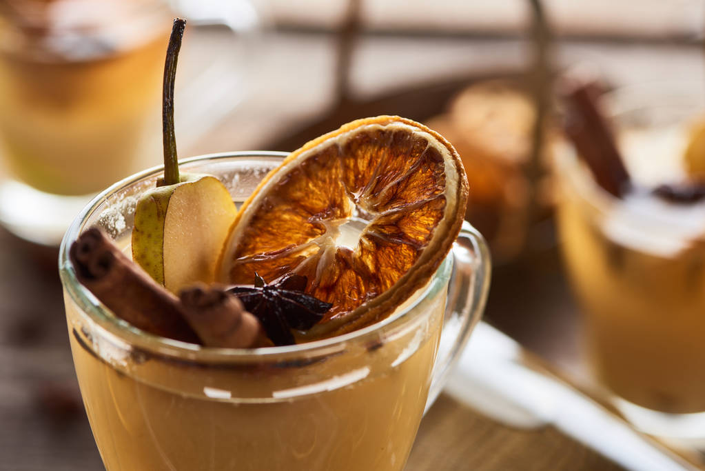 close up view of seasonal traditional pear mulled wine with spices and dried citrus in glass - Photo, Image