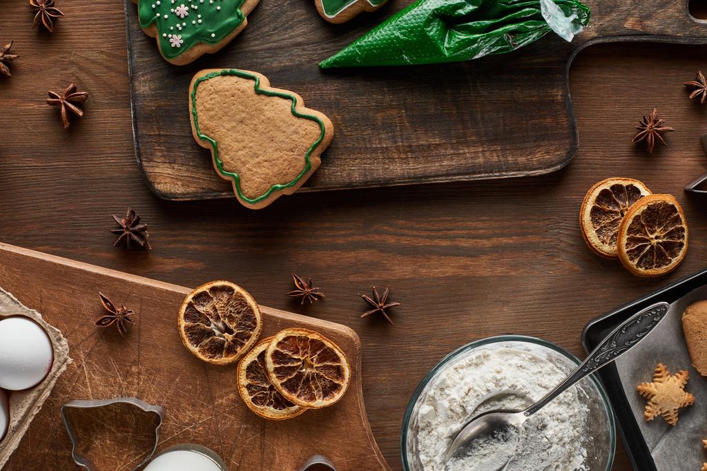 top view of Christmas cookies preparation on wooden table - Photo, Image