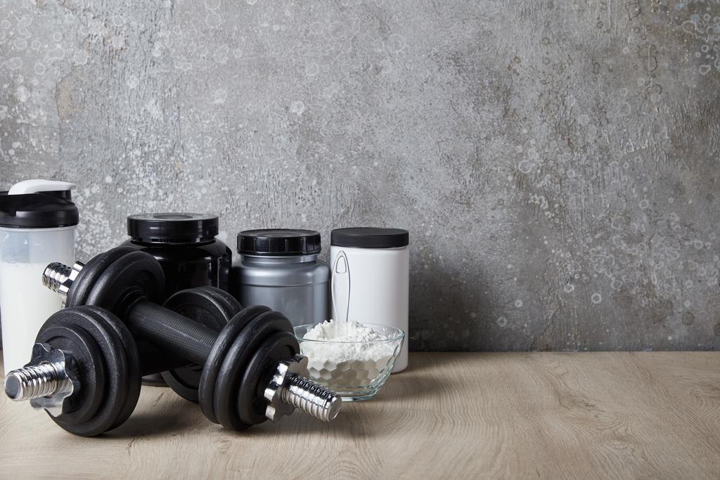 protein shake in sports bottle near jars and protein powder near concrete wall  - Photo, Image