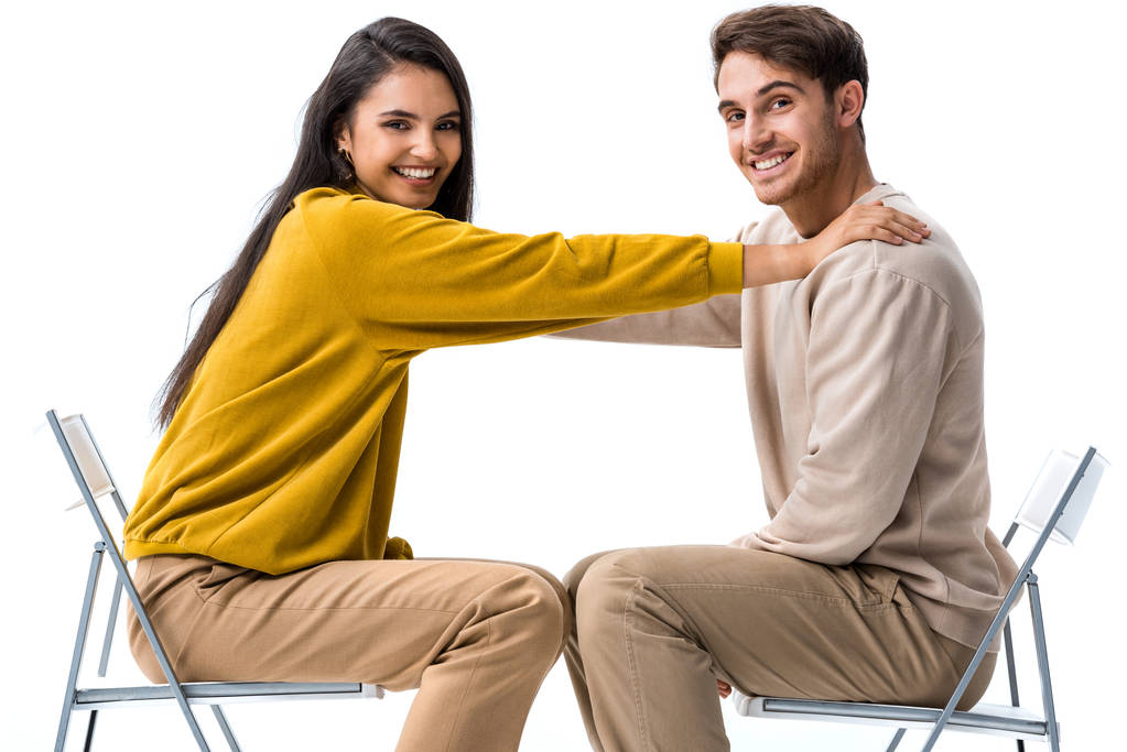 Mutlu kız sandalyede oturuyor ve beyaz adama dokunuyor.  - Fotoğraf, Görsel