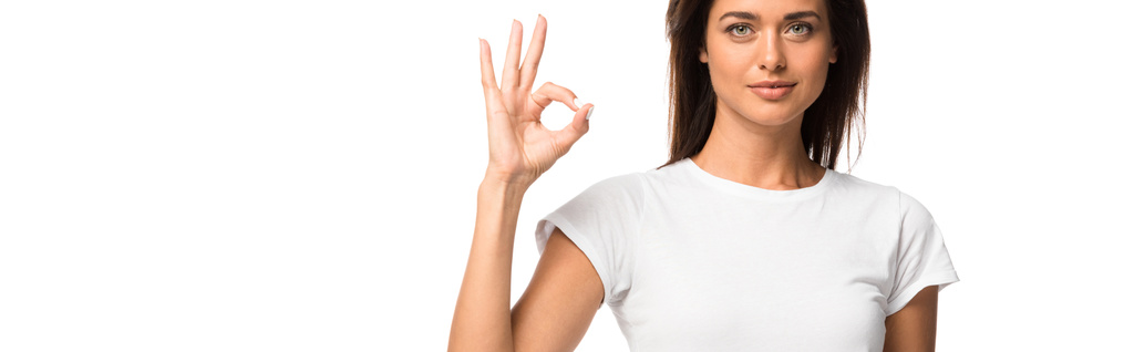 beautiful woman in white t-shirt showing ok sign, isolated on white - Photo, Image