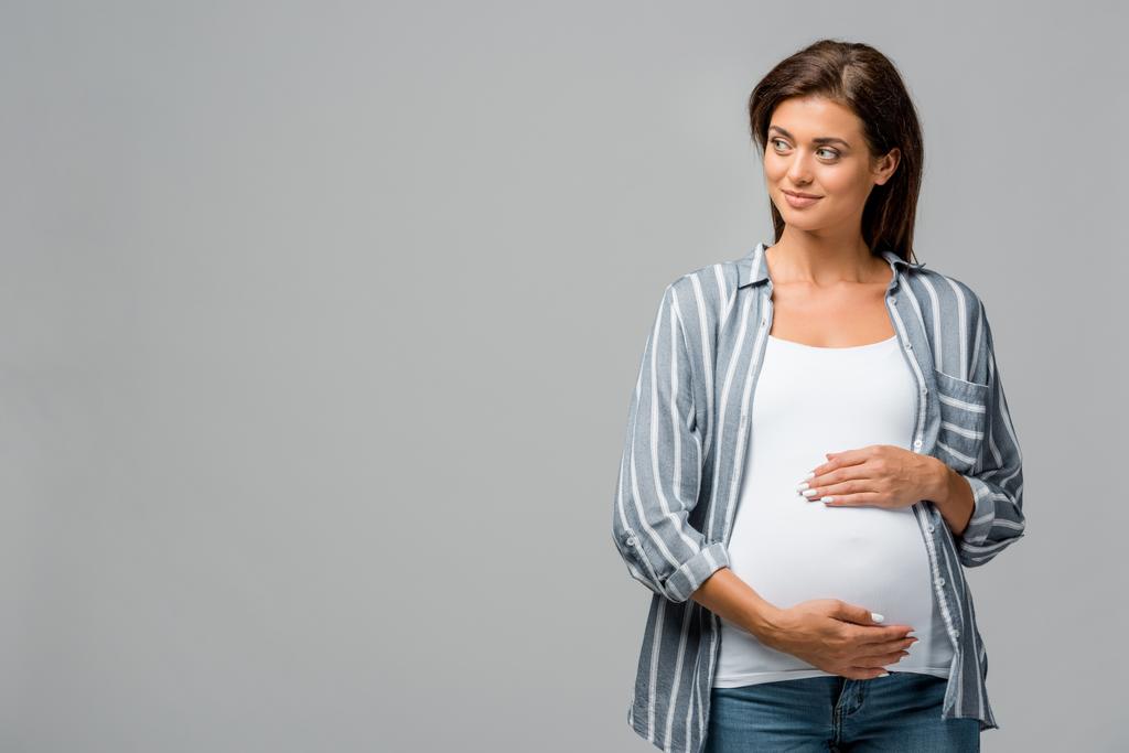 hermosa mujer embarazada tocando barriga aislado en gris
 - Foto, imagen