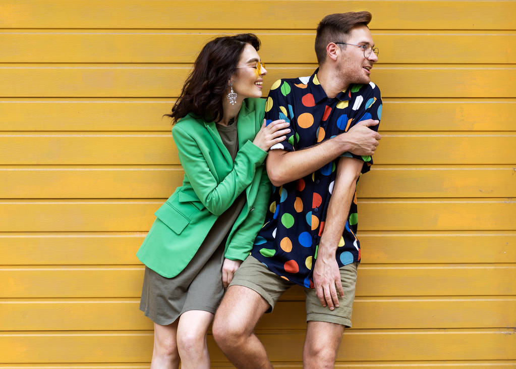 Young fashionable couple on yellow background - Photo, Image