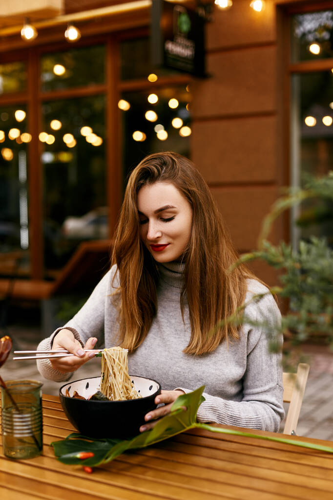 Young european girl eating ramen - Photo, Image