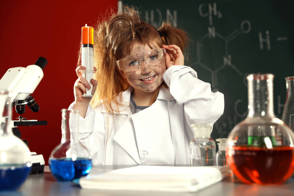Child doing chemical research in laboratory. Dangerous experiment - Photo, Image