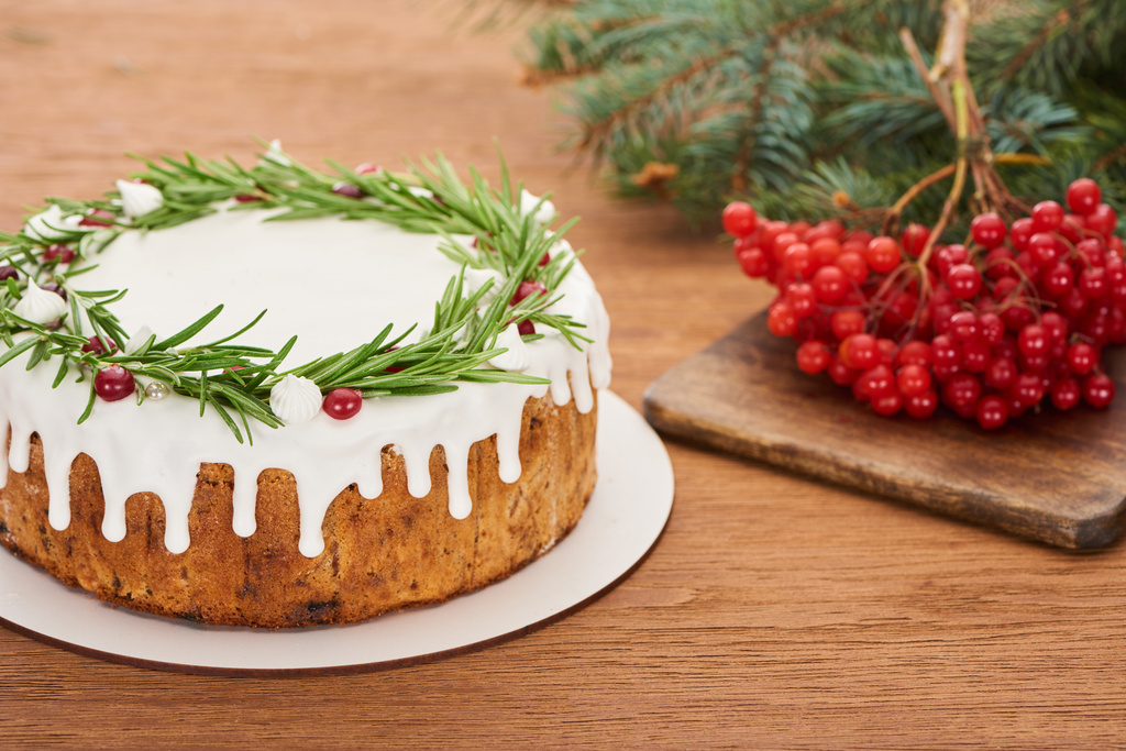 christmas pie with rosemary and viburnum berries on wooden table with spruce branches - Photo, Image