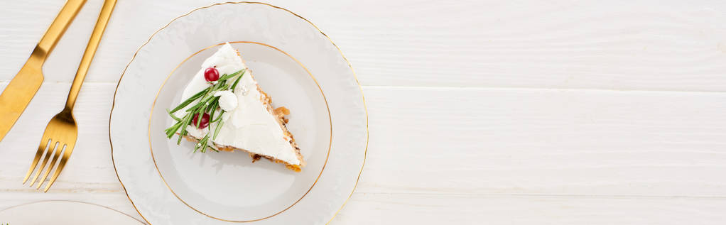 top view of christmas pie piece with fork and knife on white wooden table - Photo, Image