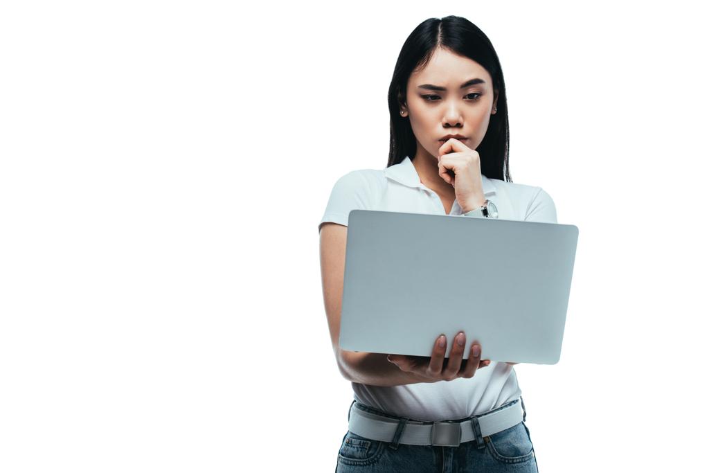 σκεπτική ασιατική κοπέλα χρησιμοποιώντας φορητό υπολογιστή απομονώνονται σε λευκό - Φωτογραφία, εικόνα