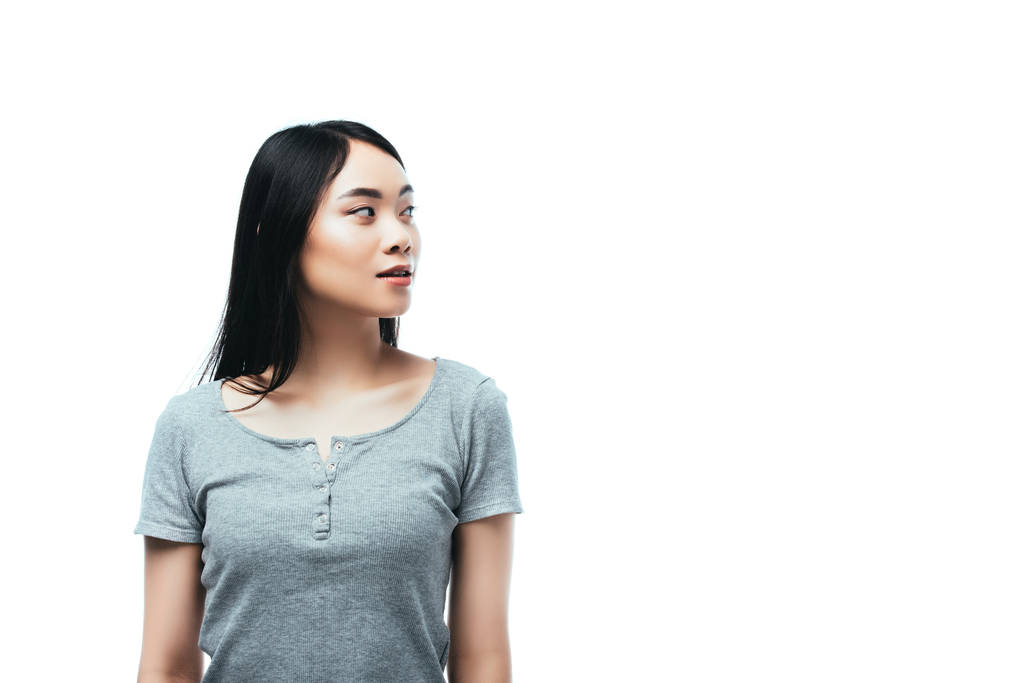 азиатская девушка смотрит в сторону изолированы на белом
 - Фото, изображение