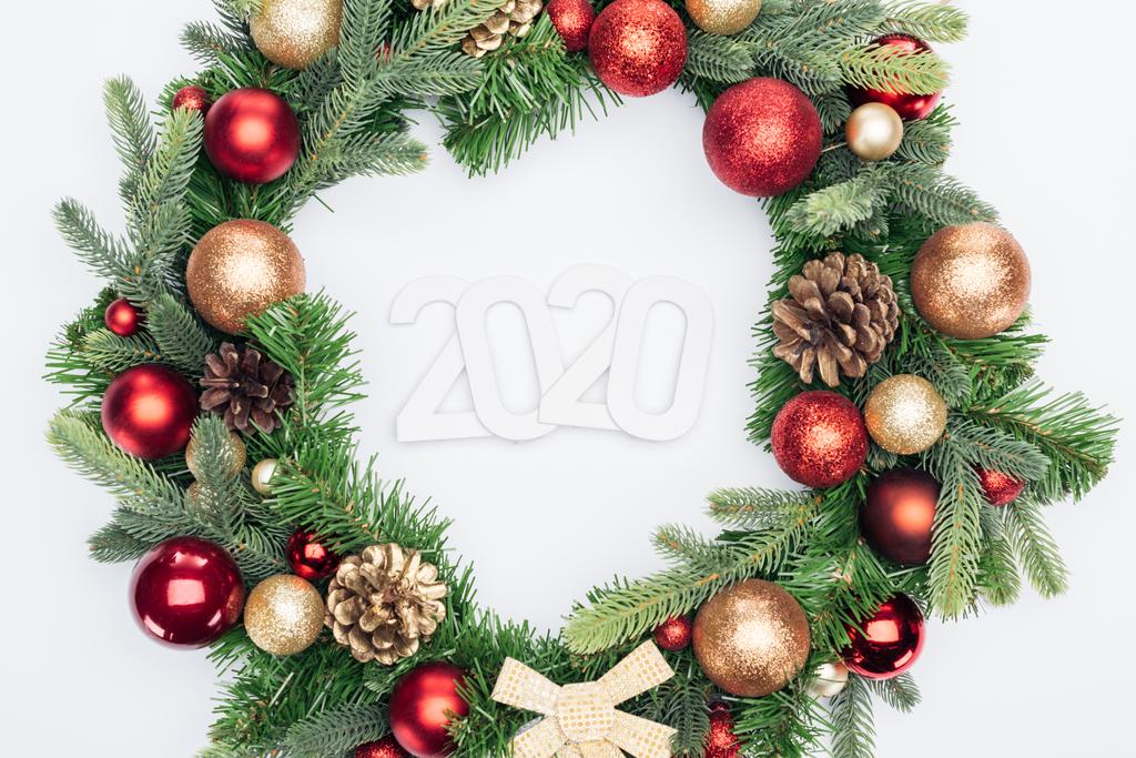 top view of 2020 numbers in Christmas tree wreath on white background - Photo, Image