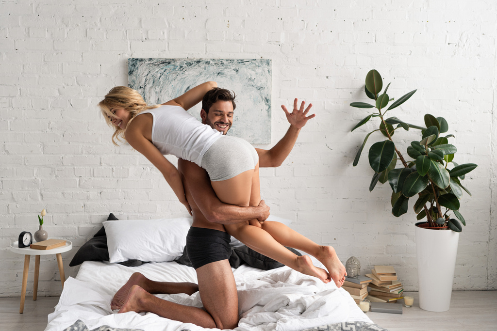 beautiful happy couple having fun in bed in the morning  - Photo, Image
