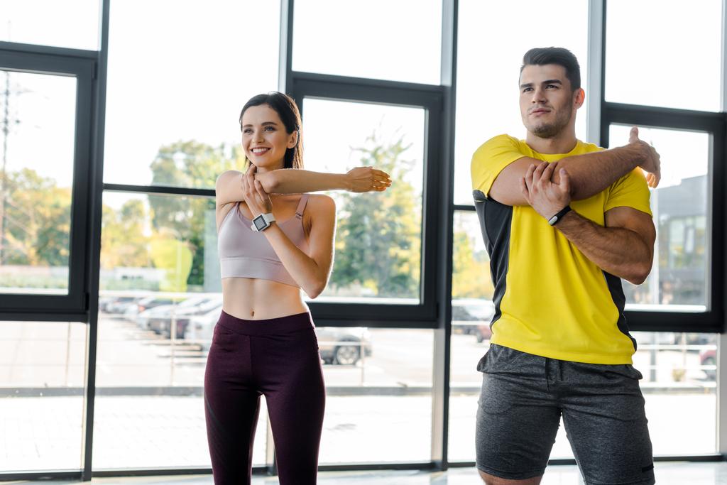 sportsman and sportswoman working out together in sports center - Photo, Image