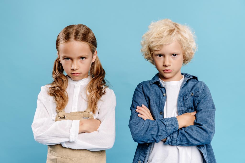 sad and cute kids with crossed arms looking at camera isolated on blue  - Photo, Image