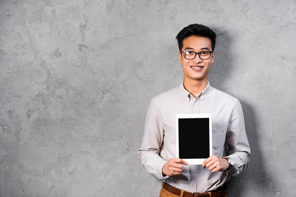 smiling asian seo manager holding digital tablet with copy space  - Photo, Image