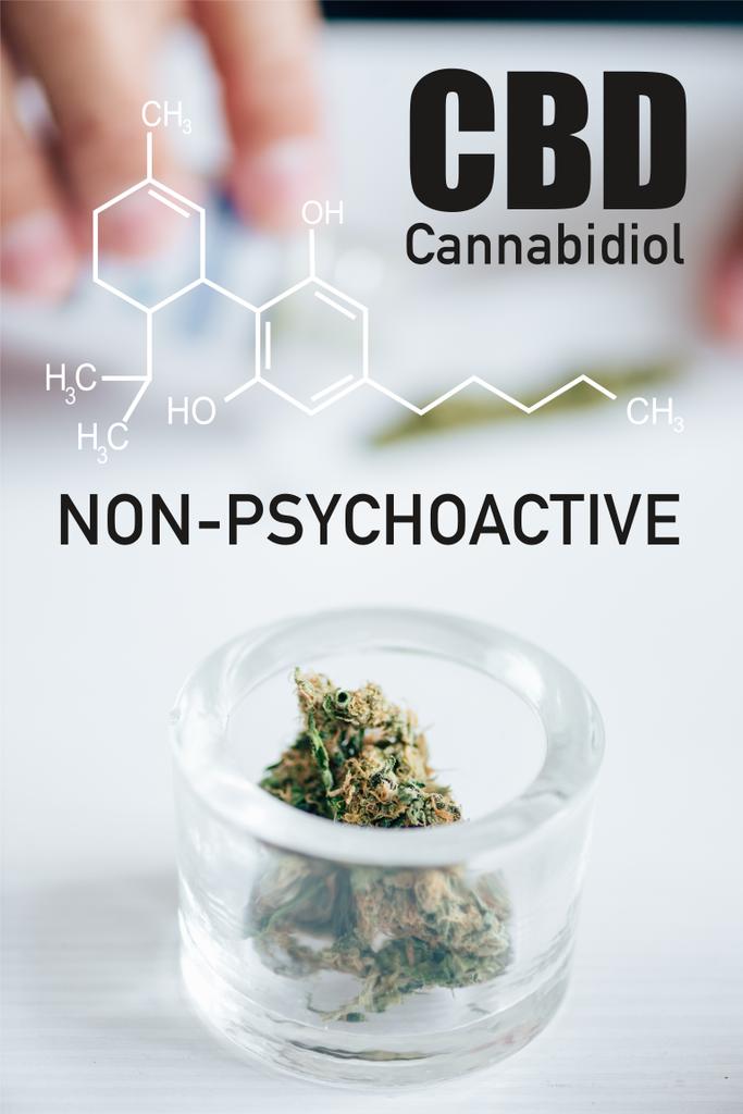 επιλεκτική εστίαση των μπουμπουκιών ιατρικής μαριχουάνας σε γυάλινη φιάλη με μη ψυχοδραστική απεικόνιση cbd - Φωτογραφία, εικόνα