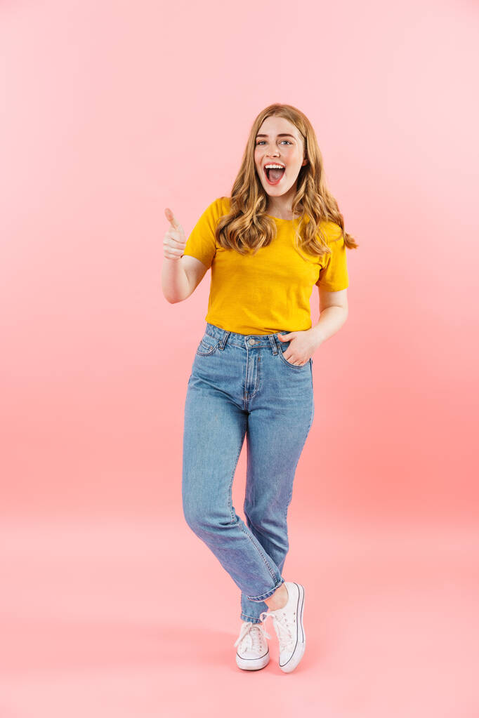Positive emotional cute girl isolated over pink wall background. - Photo, Image