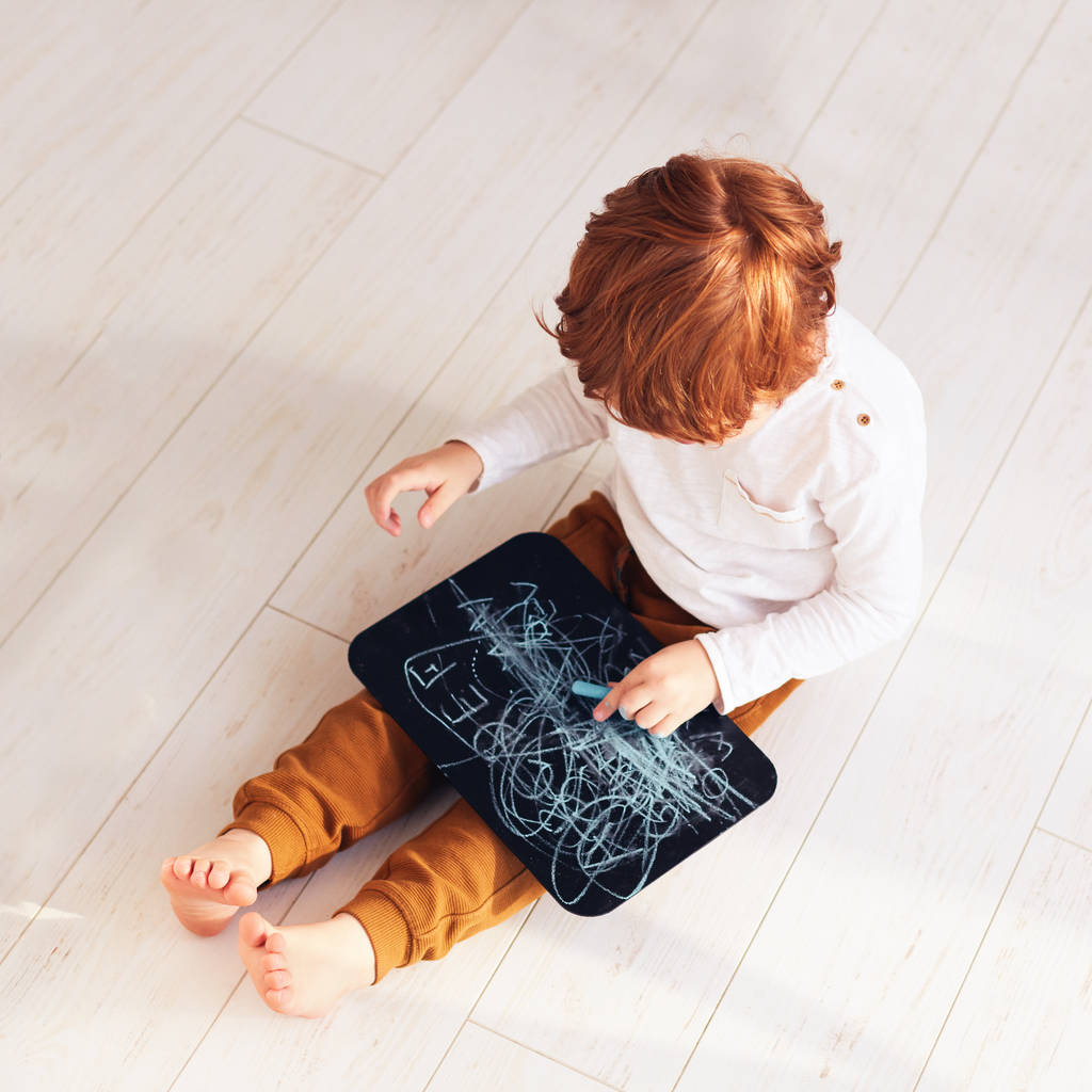 cute redhead toddler boy having fun, drawing on chalk board - Photo, Image