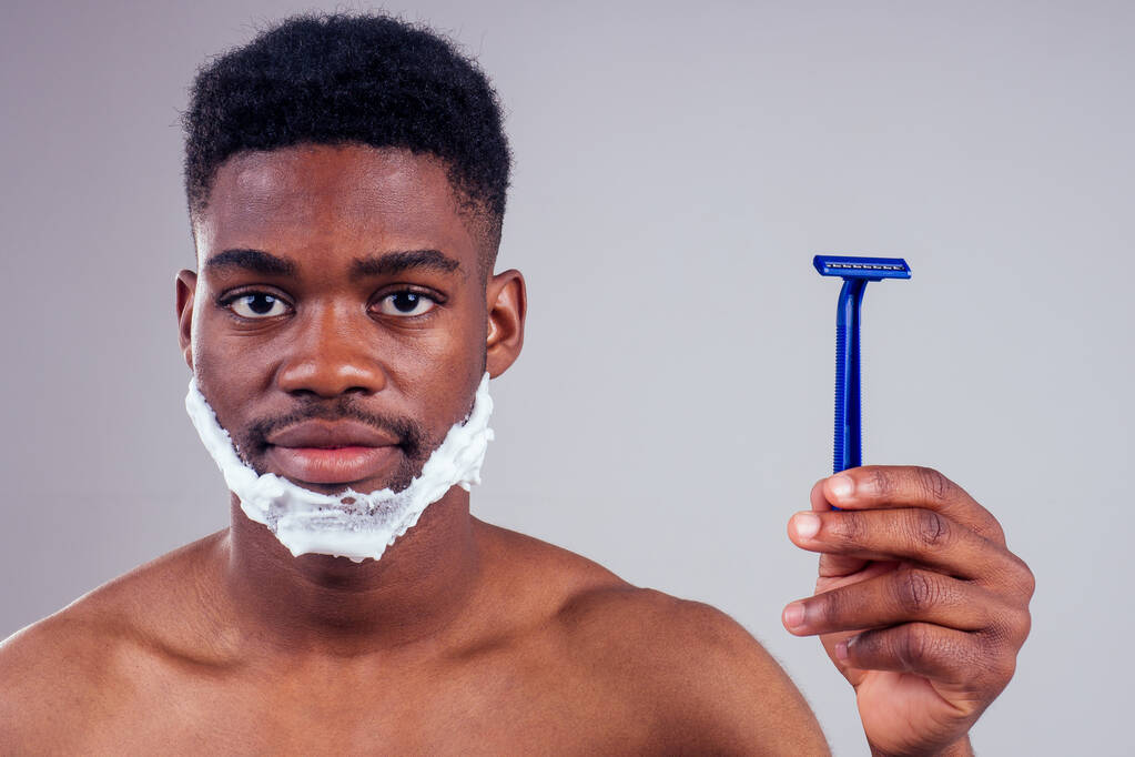 Африканский американец мужчина бритья борода студия белый фон
. - Фото, изображение