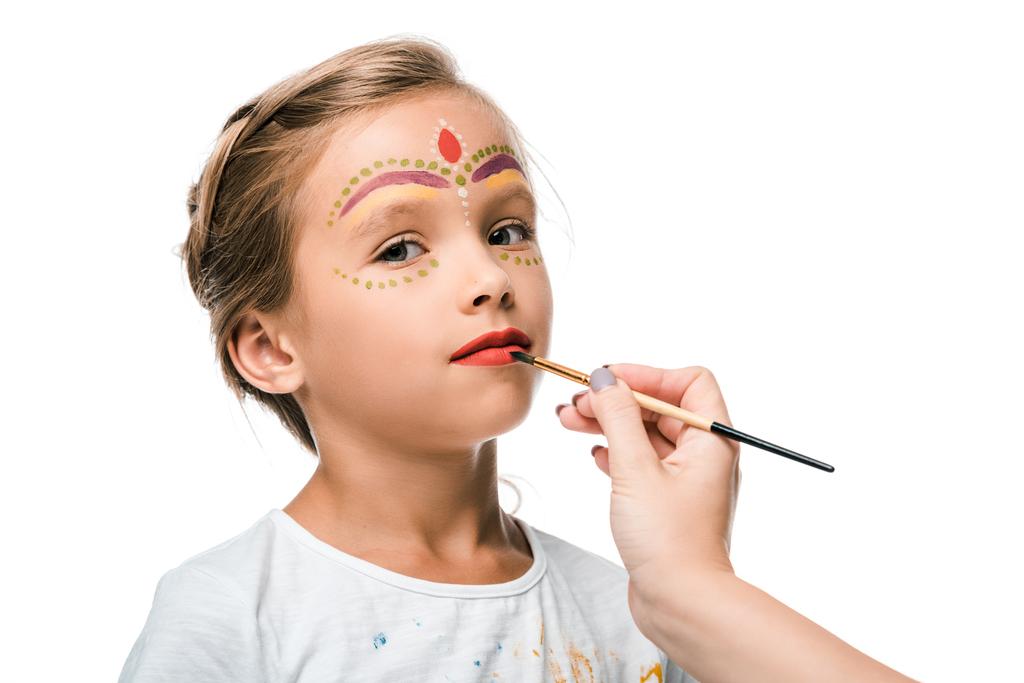 vista recortada de la mujer sosteniendo pincel cerca del niño con pintura facial aislada en blanco
  - Foto, imagen