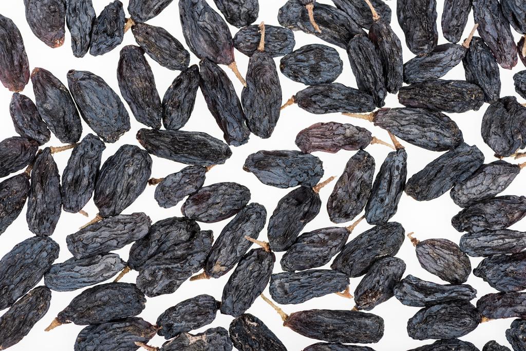 top view of black raisins isolated on white - Photo, Image